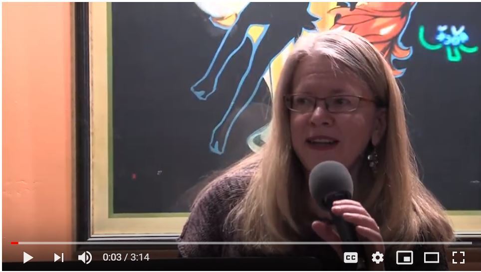 Image of Mary K. Hawley reading a poem at the Chicago AWP conference offsite reading for the Guild Literary Complex